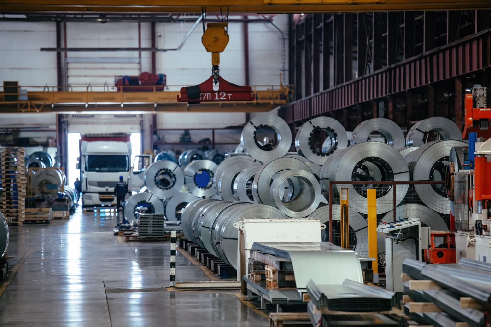 Rolls of galvanized steel sheet inside the factory or warehouse.