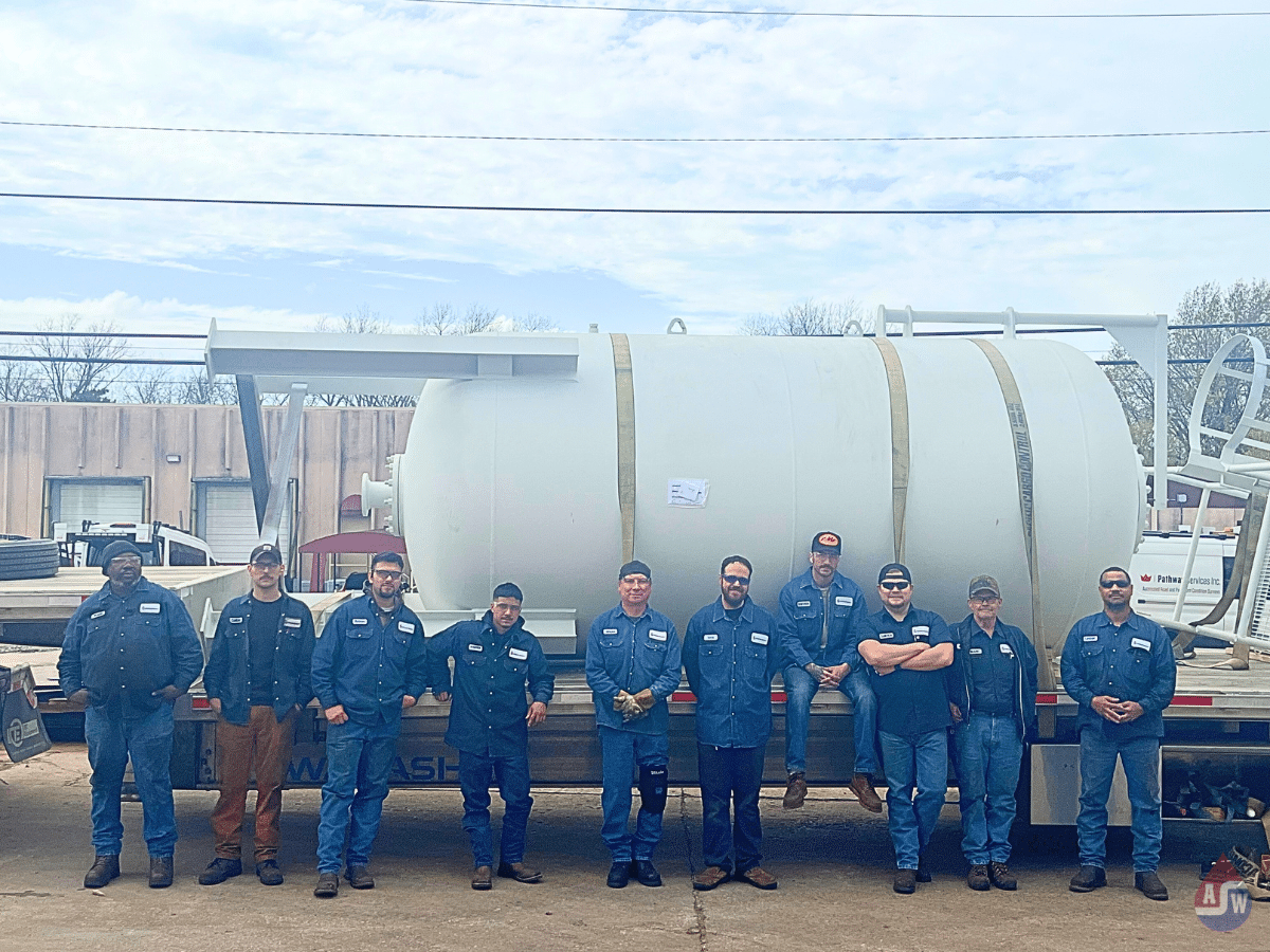 American Wheatley team in front of custom tank.